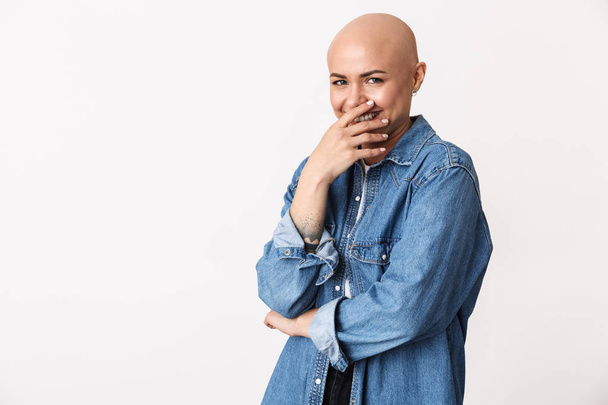 Happy bald woman posing isolated over white wall background. - 写真・画像