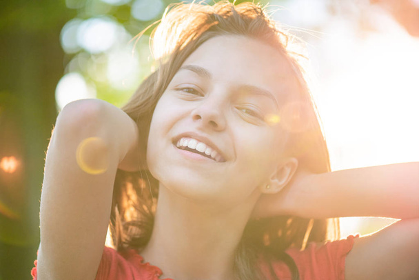 Portrait of teen girl with sun rays - Foto, Imagen