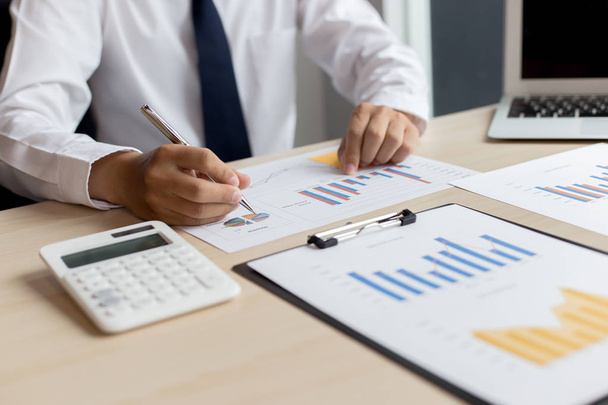 Financial and investment planning, Head of Marketing is analyzing data from the summary graph statistics for executives, business meetings. - Photo, Image
