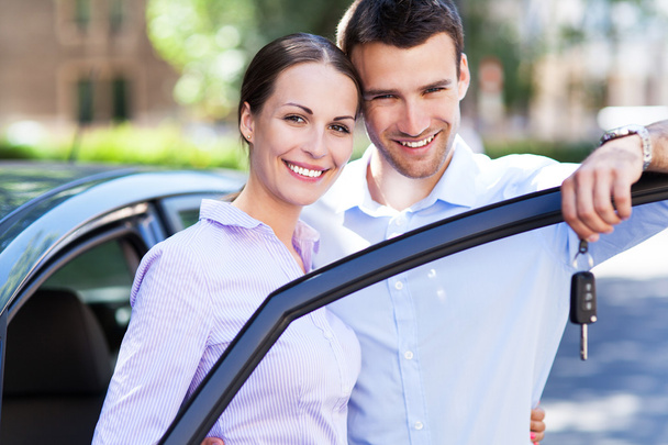 Young couple with keys to new car - Photo, image