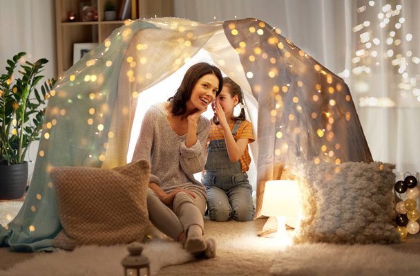 happy family whispering in kids tent at home - Foto, Imagen