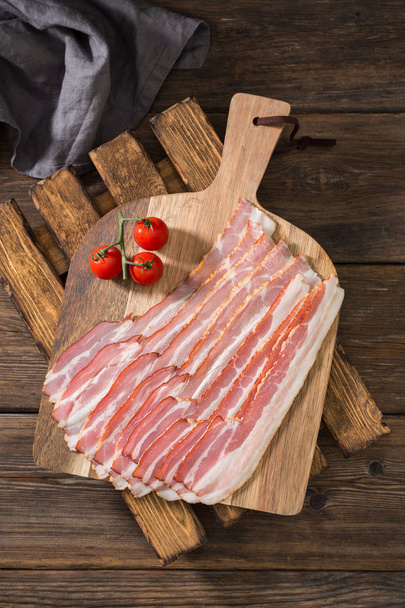 Bacon on a wooden Board on a wooden table. Rustic style - Φωτογραφία, εικόνα