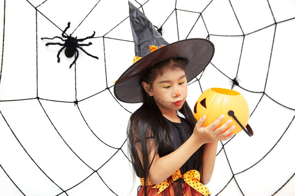 Happy Halloween little witch with a pumpkin - Zdjęcie, obraz