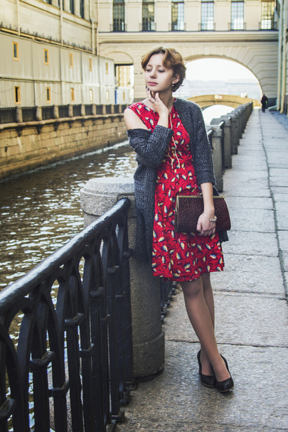 Girl with curly red hair waiting on the bridge - Valokuva, kuva