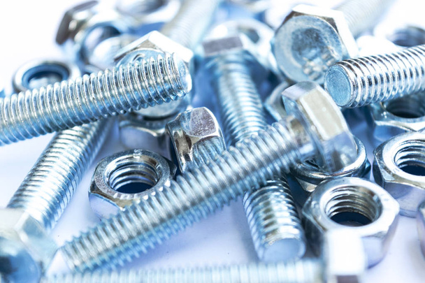 Metal bolts and nuts  in a row background. Chromed screw bolts and nuts isolated. Steel bolts and nuts pattern. Set of Nuts and bolts. Tools for work.  - Φωτογραφία, εικόνα