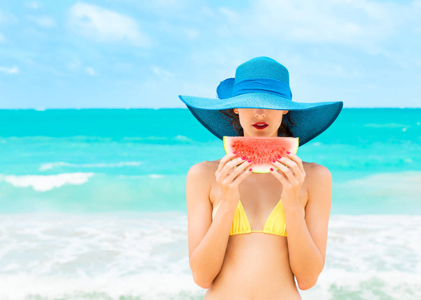 Colorful portrait of girl holding watermelon on a beautiful tropical beach.  - Foto, imagen