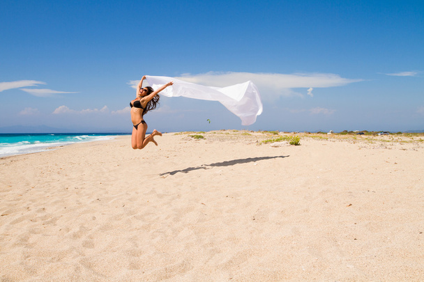 Beautiful Girl With White fabric on The Beach. - Zdjęcie, obraz