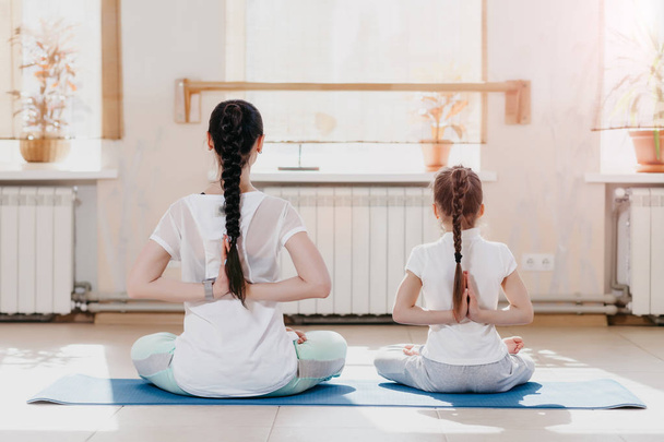 mom and daughter do yoga - Photo, Image