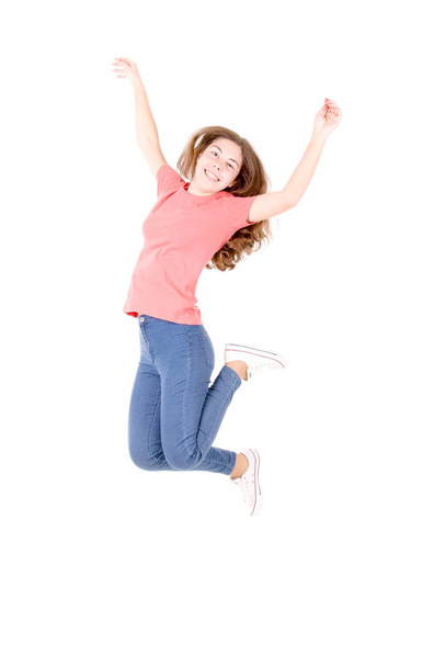 cheerful teenage girl jumping on white background  - Foto, afbeelding