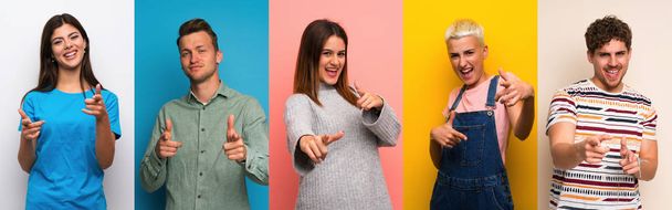 Set of people over colorful backgrounds pointing to the front and smiling - Photo, Image