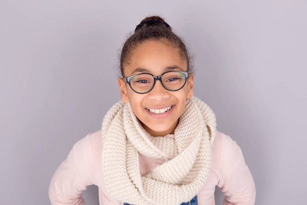 African-american ethnicity little girl posing on grey background - 写真・画像