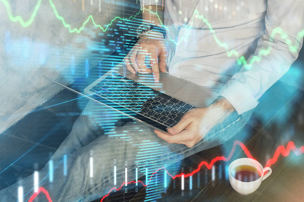 Forex graph with businessman working on computer in office on background. Concept of analysis. Double exposure. - Photo, Image