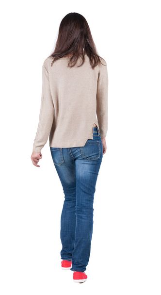 back view of walking woman in jeans . - Foto, Bild