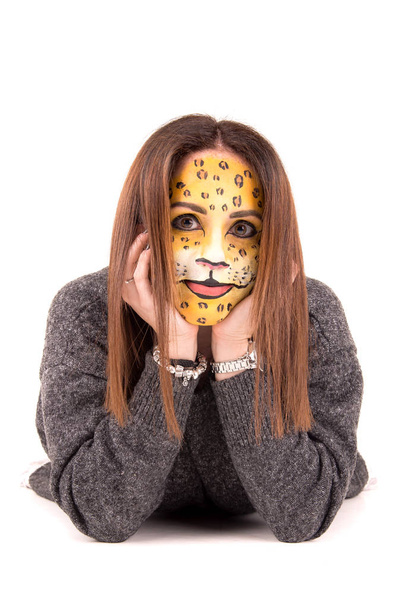 Portrait of young woman with face painted as leopard on white background  - Fotoğraf, Görsel