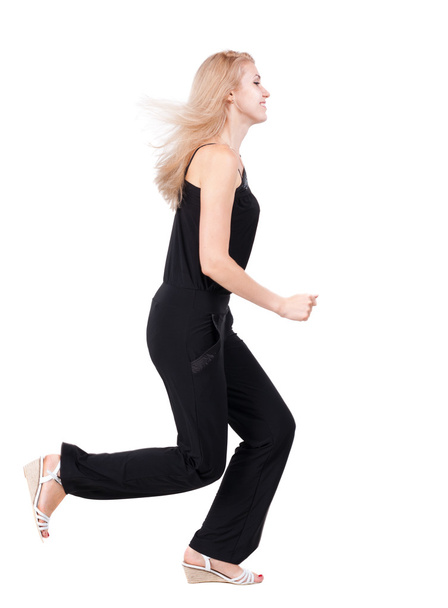 back view of running woman. beautiful blonde girl in motion. - Foto, imagen