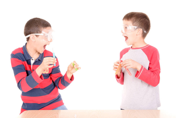 little scientist boys making experiments on white background - Foto, Imagen