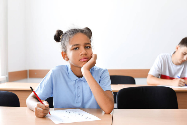 Afrikanisch-amerikanisches Teenager-Mädchen besteht Schultest im Klassenzimmer - Foto, Bild
