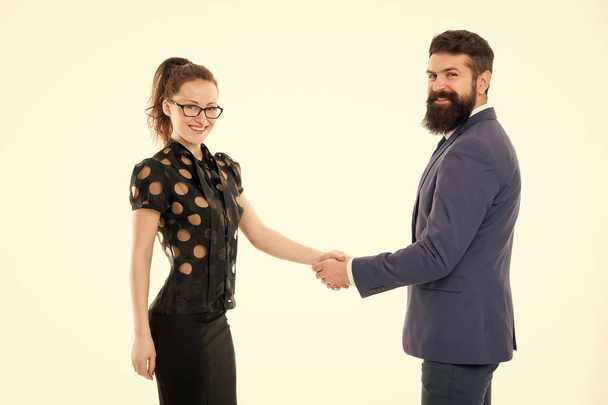Handshake successful deal. Business concept. Nothing personal just business. Colleagues man with beard and pretty woman on white background. Business partners leadership and cooperation balance - Фото, изображение