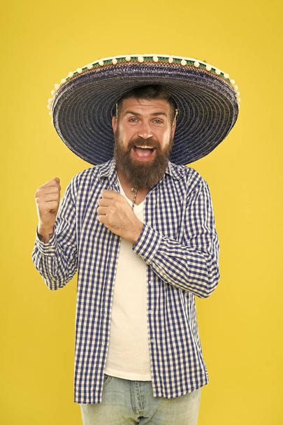 To your Mexican theme party. Hipster in wide brim hat. Mexican man wearing sombrero. Bearded man in mexican hat. Traditional fashion accessory for costume party. He is in love with mexican style - Foto, Imagen
