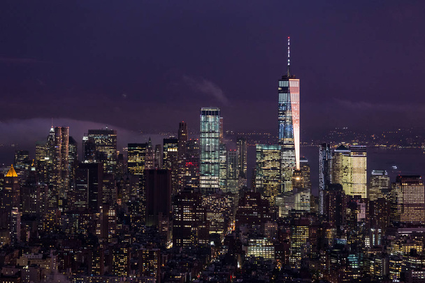 New York City skyline met lagere Manhattan wolkenkrabbers in storm 's nachts. - Foto, afbeelding