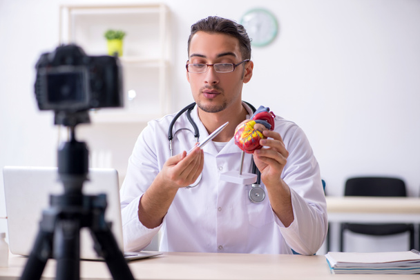 Jonge mannelijke arts cardioloog opname video voor zijn blog  - Foto, afbeelding
