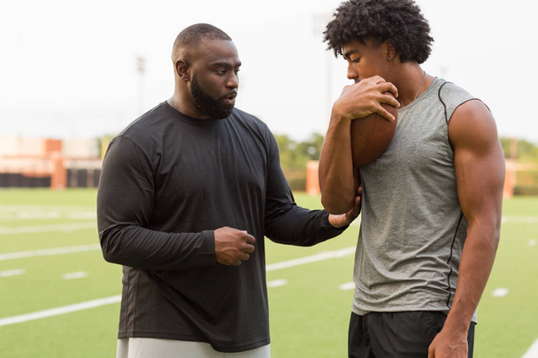 American Football coach training a young athlete. - Photo, Image
