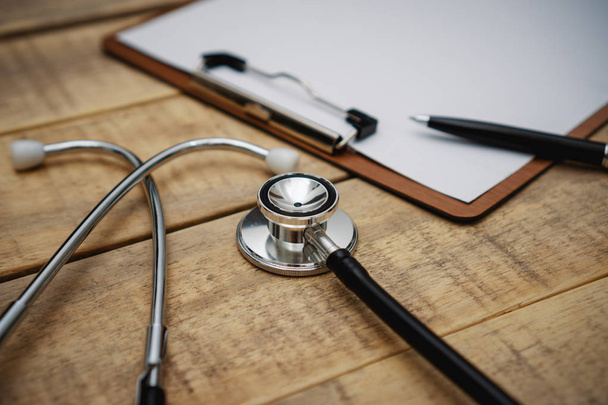 Stethoscope and Clipboard on Wood Background - Photo, Image
