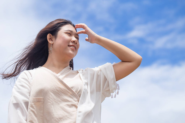 Girl teen with good healthy skin UV protection from sunny day standing happy smile with sky background - 写真・画像