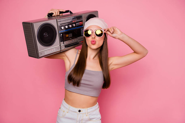 Portrait of stylish trendy person holding boombox sending air kisses wearing eyeglasses eyewear isolated over pink background - Photo, Image