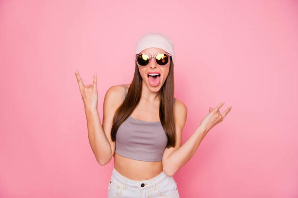 Portrait of childish person teen making horns shouting grimacing wearing eyewear eyeglasses isolated over pink background - Фото, изображение