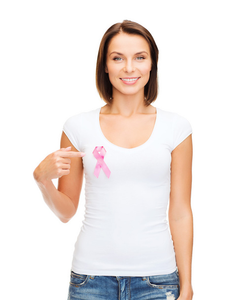 Woman in blank t-shirt with pink cancer ribbon - Фото, изображение