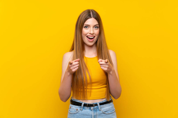 Молодая женщина на изолированном желтом фоне указывает пальцем на тебя
 - Фото, изображение