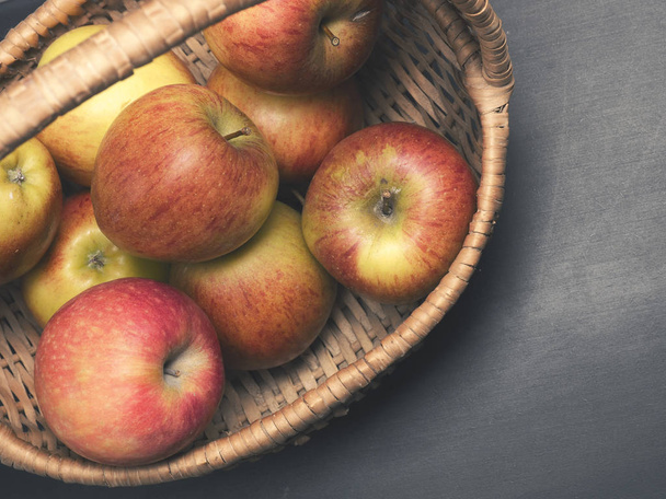 Fresh organic apples in a basket - Фото, изображение