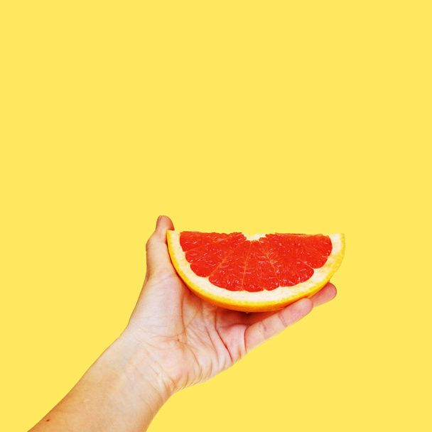 Грейпфрут в руке на ярком фоне. Коллаж современного искусства
 - Фото, изображение