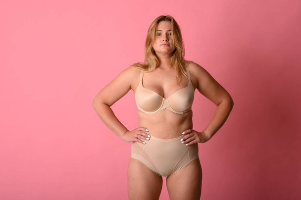 attractive chubby girl in underwear on pink background - Фото, зображення