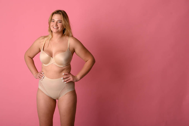 attractive chubby girl in underwear on pink background - Φωτογραφία, εικόνα