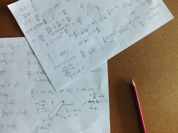 The mathematical equations on a sheet of paper on desk - Photo, Image