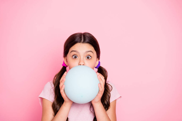 Close up photo of charming kid holding white baloon inflate wearing t-shirt isolated over pink background - Fotoğraf, Görsel