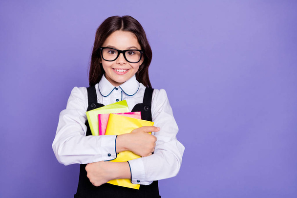 Close-up portrait of nice attractive cheerful cheery diligent intellectual wavy-haired pre-teen girl holding in hands academic literature isolated over bright vivid shine violet background - Zdjęcie, obraz