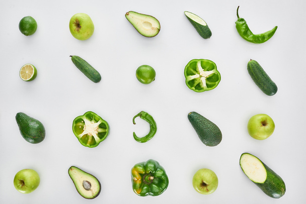 top view of green apples, avocados, cucumbers, kiwi, limes, peppers and zucchini - 写真・画像