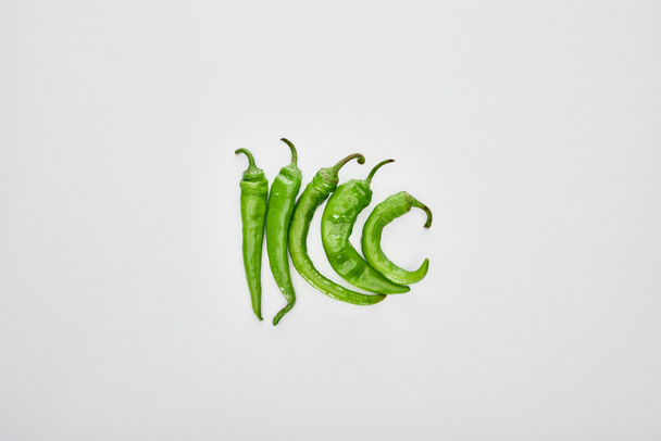 top view of fresh and green peppers on white background   - Фото, зображення