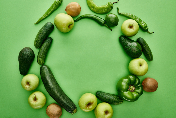 top view of apples, avocados, cucumbers, lime, peppers, kiwi and zucchini - Photo, Image