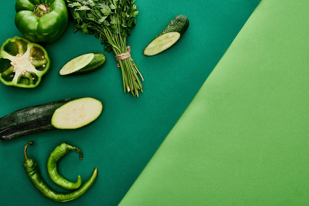 top view of fresh and green cucumbers, peppers, greenery and zucchini - Fotoğraf, Görsel