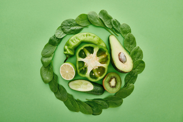 top view of avocado, cucumber, peppers, kiwi, greenery and lime  - Fotoğraf, Görsel