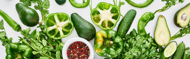 panoramic shot of spices, peppers, greenery, cucumbers and avocados  - Photo, Image