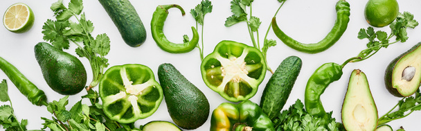 panoramic shot of limes, peppers, greenery, cucumbers and avocados  - Photo, Image