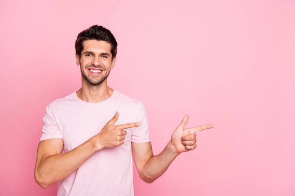 Portrait of his he nice attractive cheerful cheery confident content guy pointing two forefingers aside promotion surprise ad advert isolated over pink pastel background - Fotografie, Obrázek