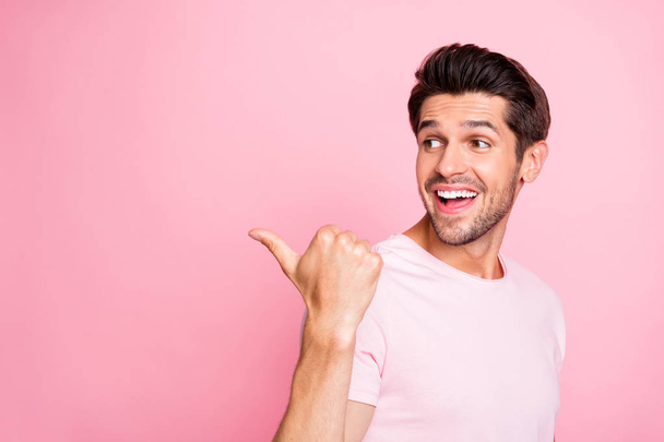 Close-up portrait of his he nice attractive confident cheerful cheery glad excited guy pointing aside ad advert copy space surprise isolated over pink pastel background - Valokuva, kuva