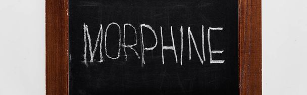 panoramic shot of black chalk board with lettering morphine - Фото, зображення