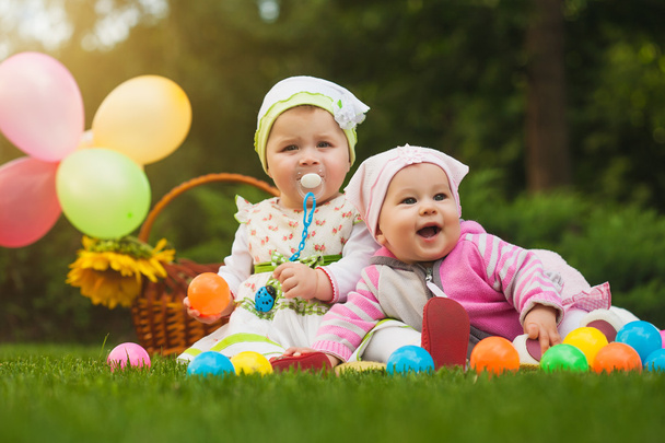 Cute babies are playing on the green grass - Photo, image